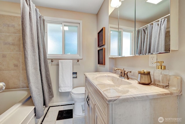 full bathroom with toilet, plenty of natural light, tile patterned floors, and vanity