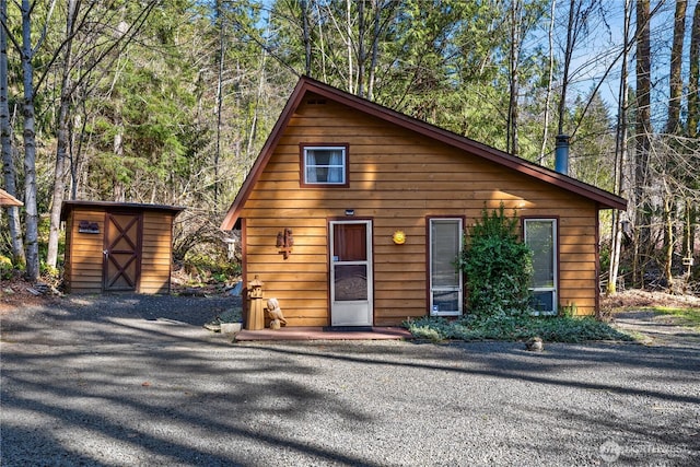 81 N Fawn Dr, Hoodsport, WA 98548 - view of front of home with an outdoor structure and a storage shed