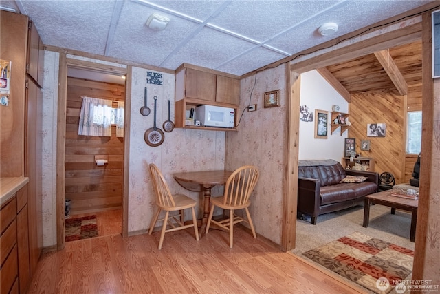 81 N Fawn Dr, Hoodsport, WA 98548 - dining room featuring wood walls and light wood-style flooring