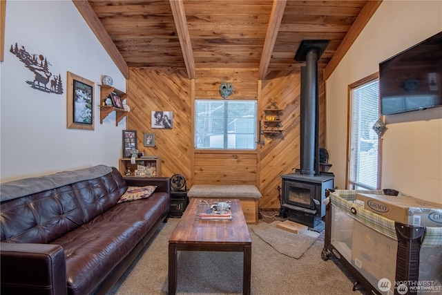 81 N Fawn Dr, Hoodsport, WA 98548 - living room with carpet floors, a wood stove, wooden walls, vaulted ceiling with beams, and wooden ceiling