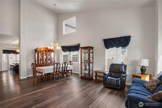 11234 SE 299th Pl, Auburn, WA 98092 - living room featuring a chandelier, a towering ceiling, baseboards, and wood finished floors