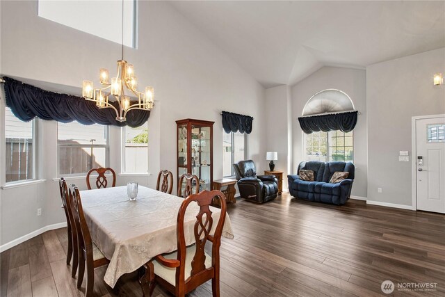 11234 SE 299th Pl, Auburn, WA 98092 - dining area with an inviting chandelier, dark wood-style flooring, baseboards, and high vaulted ceiling