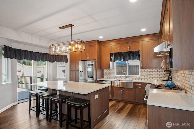 11234 SE 299th Pl, Auburn, WA 98092 - kitchen featuring a sink, stainless steel appliances, dark wood finished floors, backsplash, and a kitchen island