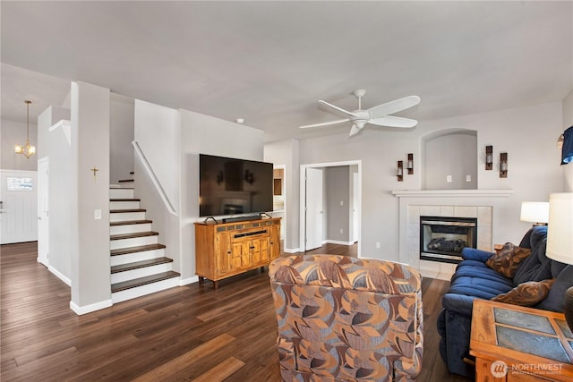 11234 SE 299th Pl, Auburn, WA 98092 - living area featuring a tile fireplace, stairway, baseboards, ceiling fan, and dark wood-style floors
