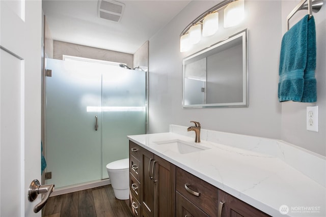11234 SE 299th Pl, Auburn, WA 98092 - full bath with a stall shower, toilet, visible vents, vanity, and wood finished floors
