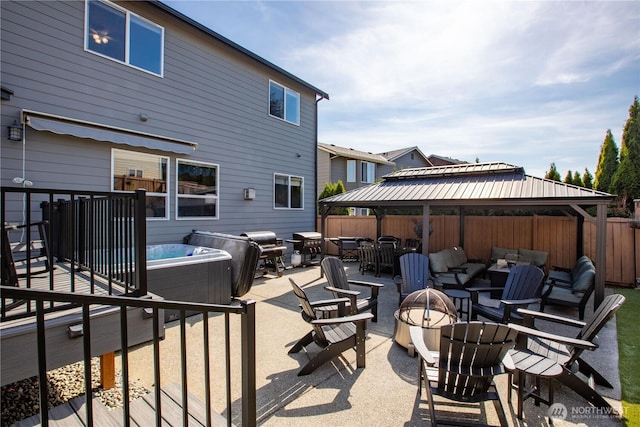 11234 SE 299th Pl, Auburn, WA 98092 - view of patio featuring a hot tub, a gazebo, fence, and an outdoor living space with a fire pit