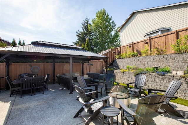 11234 SE 299th Pl, Auburn, WA 98092 - view of patio featuring an outdoor fire pit, outdoor dining space, a gazebo, and a fenced backyard