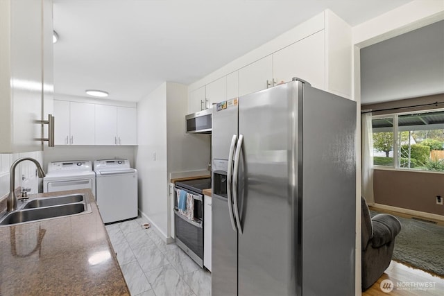 30573 5th Ave SW, Federal Way, WA 98023 - kitchen with a sink, stainless steel appliances, independent washer and dryer, visible vents, and white cabinetry