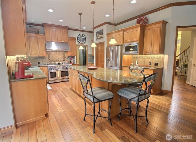 2116 263rd Pl SE, Sammamish, WA 98075 - kitchen featuring a center island, ornamental molding, stainless steel appliances, and under cabinet range hood