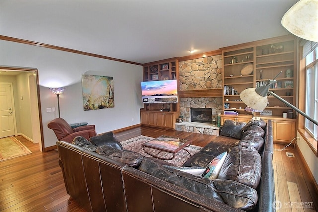 2116 263rd Pl SE, Sammamish, WA 98075 - living area with crown molding, baseboards, hardwood / wood-style flooring, and a fireplace