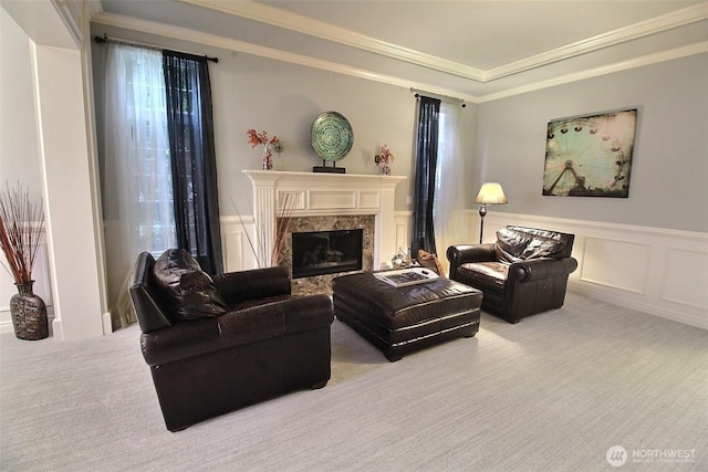 2116 263rd Pl SE, Sammamish, WA 98075 - carpeted living area with a premium fireplace, ornamental molding, a wainscoted wall, and a decorative wall