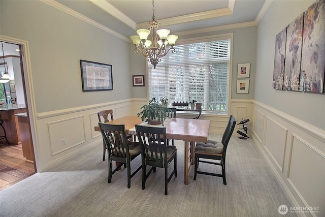 2116 263rd Pl SE, Sammamish, WA 98075 - dining space with crown molding, a decorative wall, light carpet, and an inviting chandelier