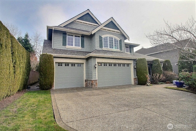 2116 263rd Pl SE, Sammamish, WA 98075 - view of front of property featuring fence, driveway, stone siding, and a garage