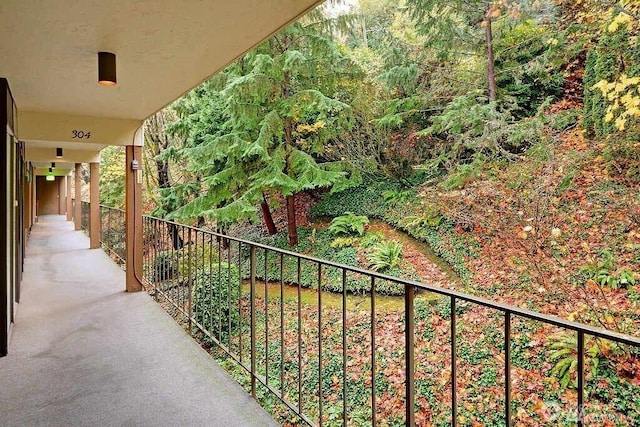 balcony featuring a forest view