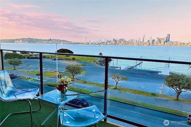 balcony with a view of city and a water view