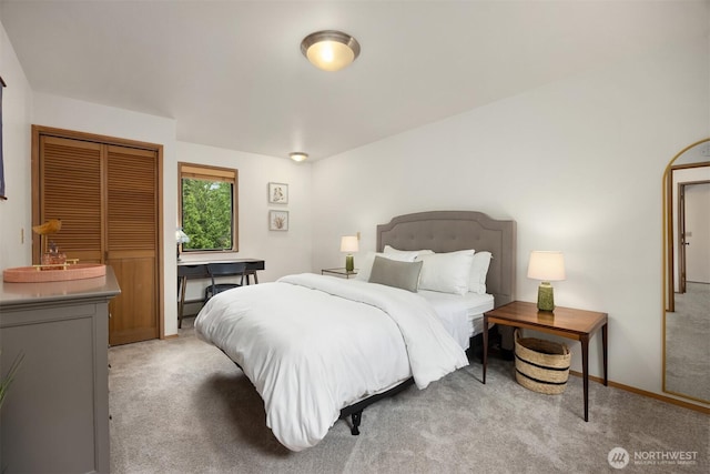 bedroom featuring light carpet and a closet