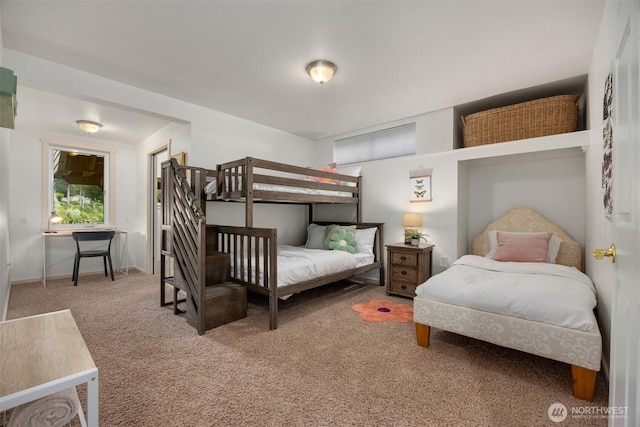 bedroom with baseboards and carpet