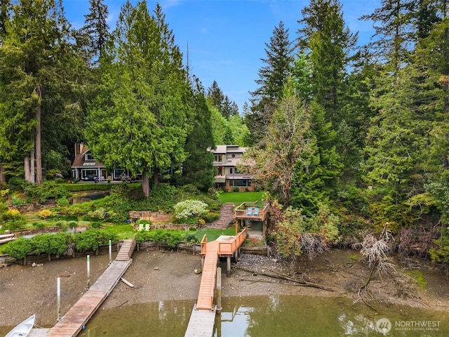 dock area with a view of trees and a water view