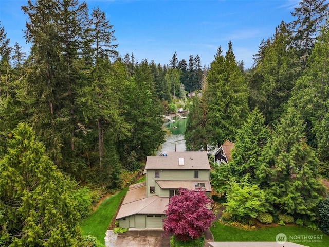 drone / aerial view featuring a wooded view