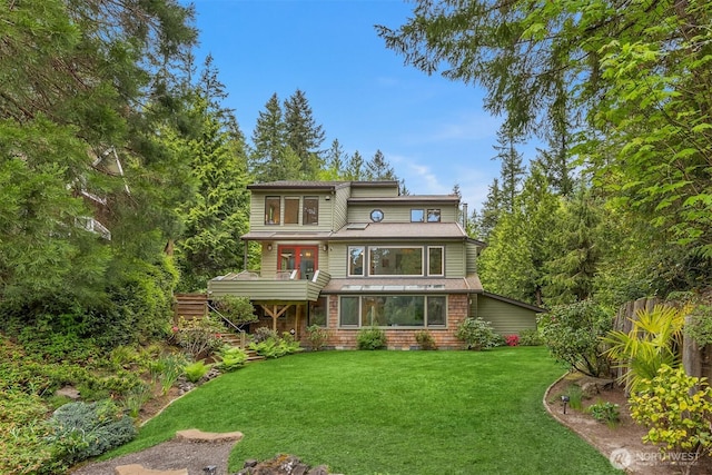 back of property featuring a lawn