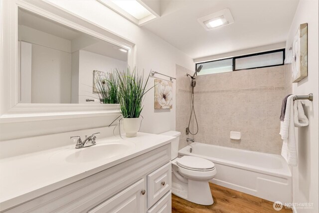 full bathroom with vanity, bathing tub / shower combination, toilet, and wood finished floors