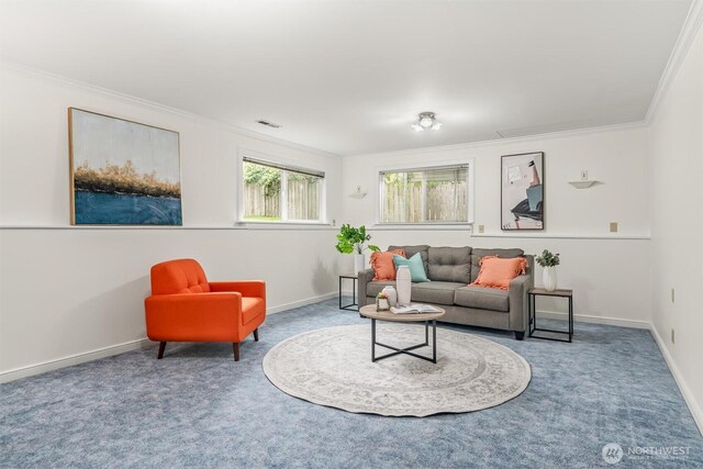 living room with carpet floors, ornamental molding, and baseboards