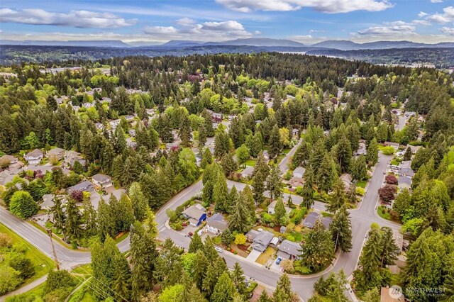 birds eye view of property featuring a mountain view and a forest view