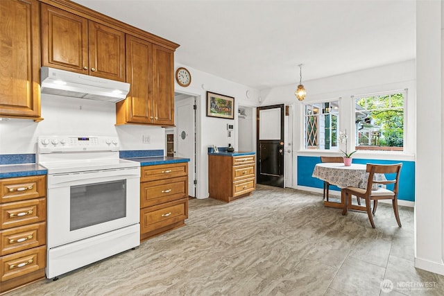 kitchen with dark countertops, brown cabinets, baseboards, electric stove, and under cabinet range hood