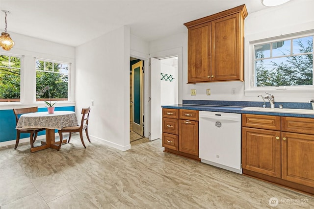 kitchen featuring brown cabinetry, a healthy amount of sunlight, a sink, and dishwasher