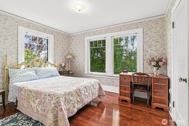 bedroom featuring multiple windows, ornamental molding, wallpapered walls, and wood finished floors