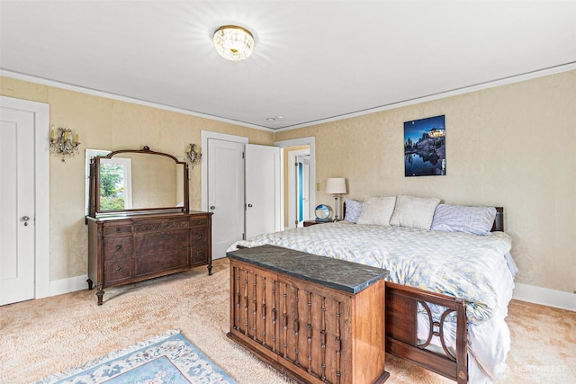 bedroom featuring crown molding, baseboards, and light carpet