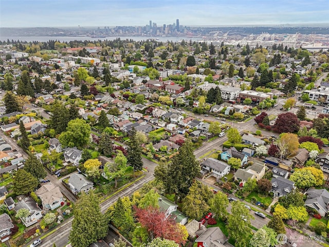drone / aerial view featuring a water view and a residential view