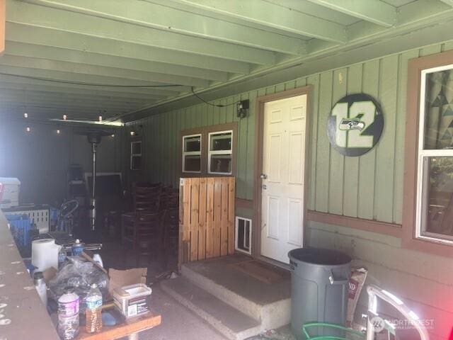 entrance to property featuring covered porch and board and batten siding