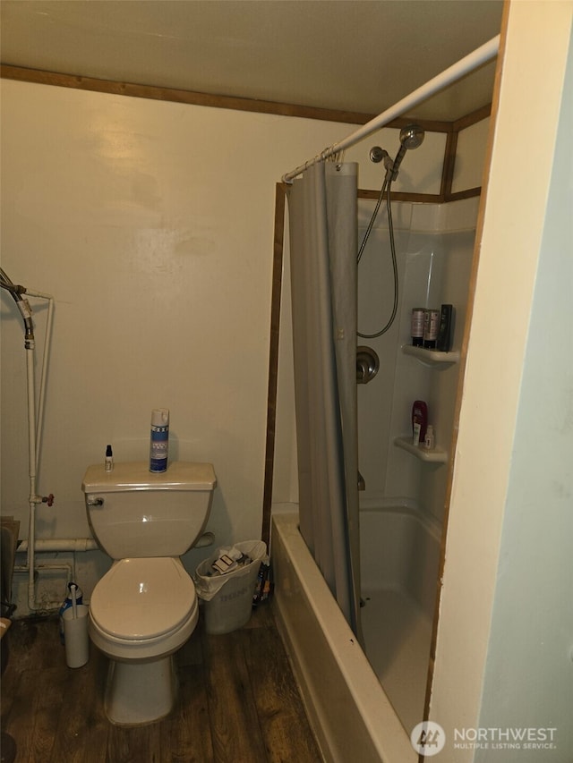 bathroom with toilet, wood finished floors, and shower / tub combo