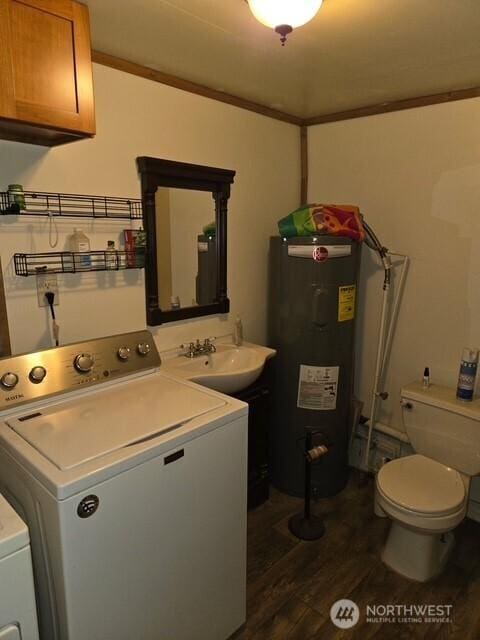 clothes washing area with laundry area, crown molding, dark wood-style flooring, a sink, and water heater