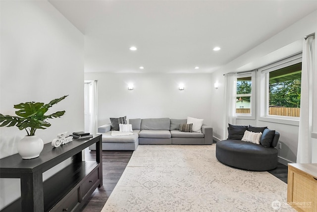 living room with recessed lighting and dark wood-style floors