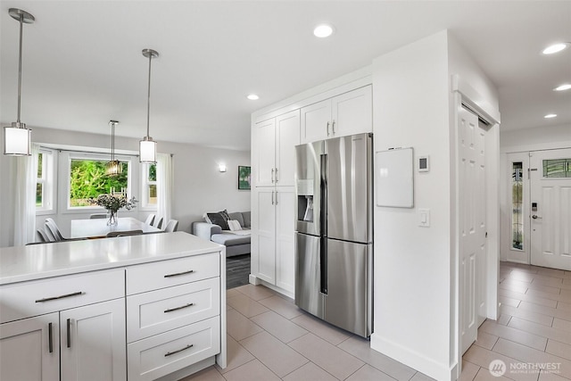 kitchen featuring white cabinets, stainless steel fridge with ice dispenser, light countertops, recessed lighting, and light tile patterned floors