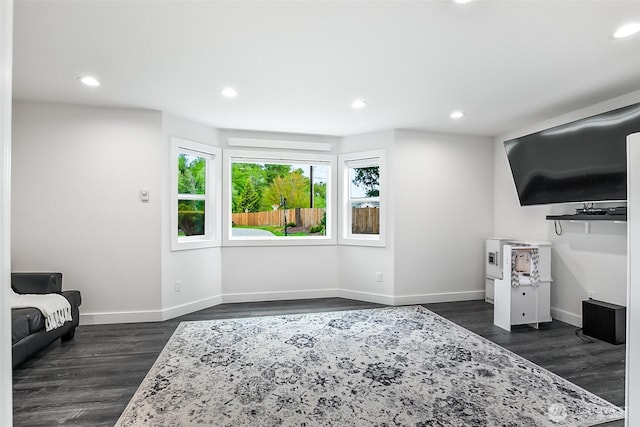living area with baseboards, recessed lighting, and dark wood finished floors