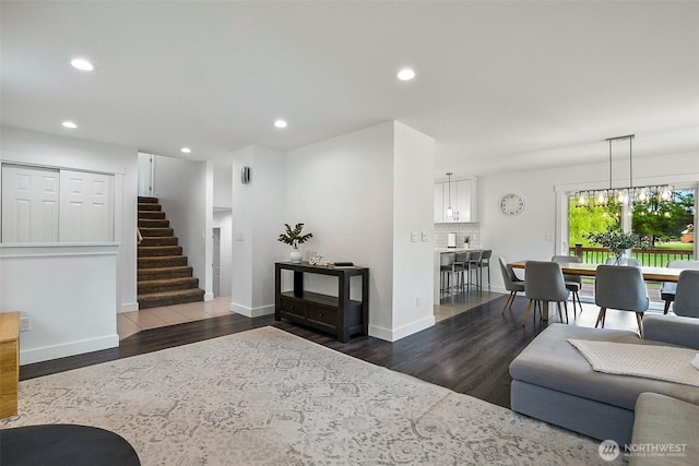 living area with baseboards, recessed lighting, and dark wood-type flooring