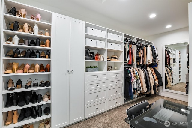 walk in closet featuring carpet