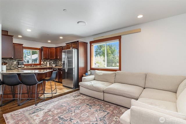 living area with recessed lighting and light wood-style flooring