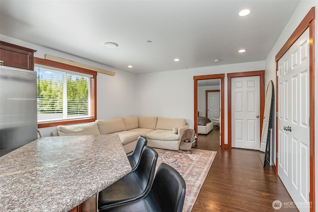 living area featuring recessed lighting and dark wood finished floors