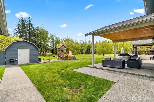 view of yard with an outdoor living space, a storage shed, an outdoor structure, a playground, and a patio