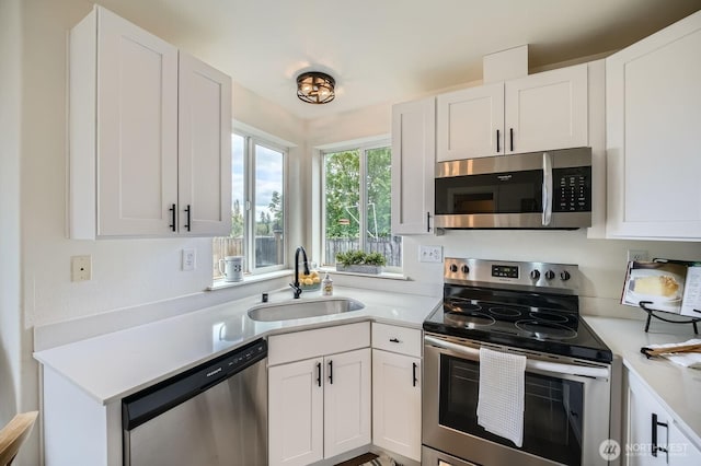kitchen featuring a sink, appliances with stainless steel finishes, and light countertops