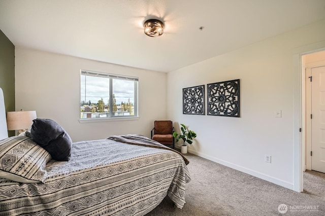 carpeted bedroom featuring baseboards