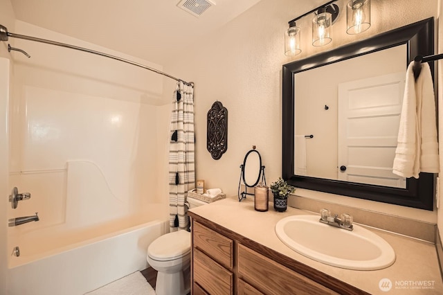 bathroom featuring toilet, visible vents, shower / bath combo, and vanity
