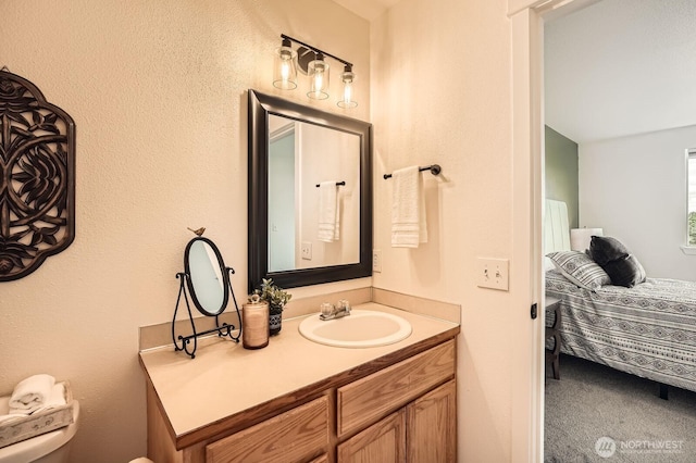 bathroom with vanity, toilet, and ensuite bath
