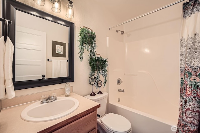 full bathroom featuring vanity, shower / bath combo, and toilet