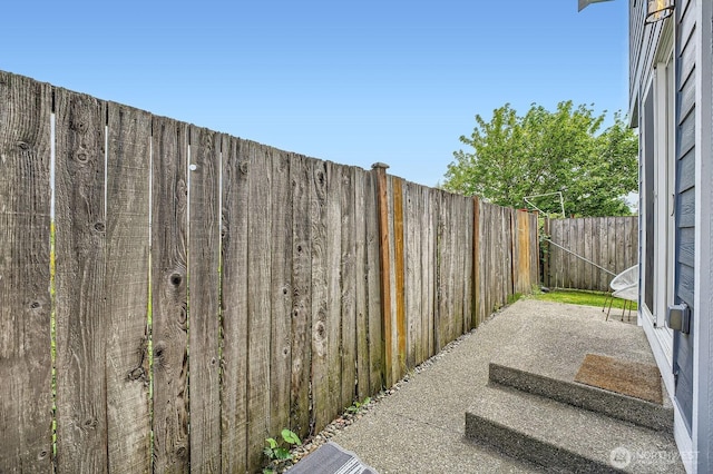 exterior space with a fenced backyard and a patio area