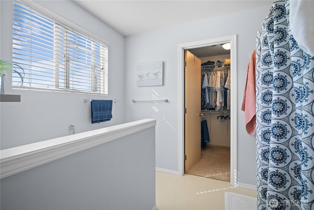 1810 Johnson Ave, Dupont, WA 98327 - full bathroom with baseboards, a shower with shower curtain, and a walk in closet